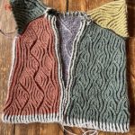 complicated brioche knitting project freed from needles, still needs sleeves